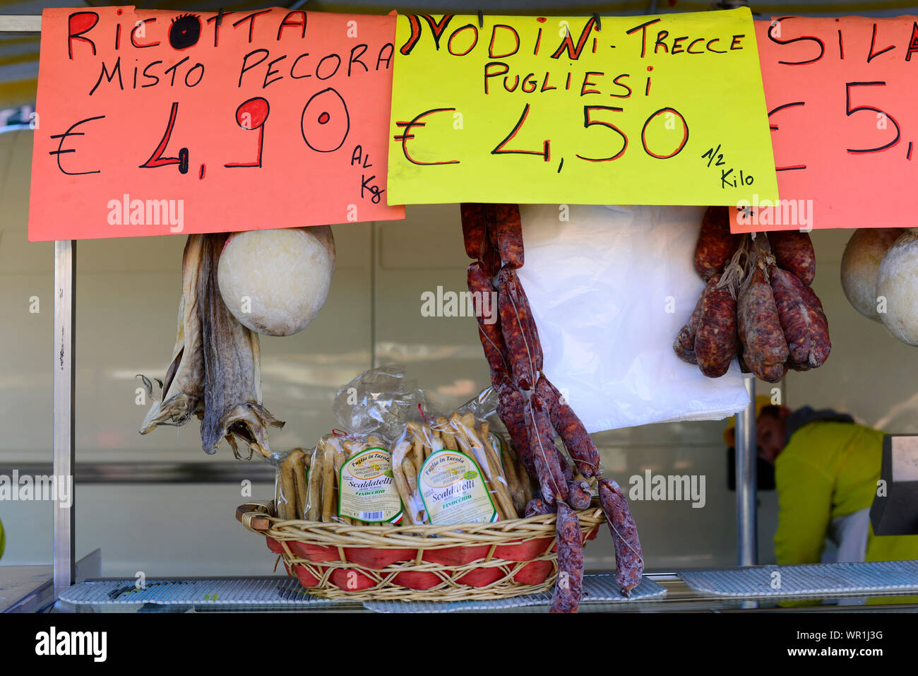 Cured meats and Ricotta cheese stall at the market in Bra, Italy. Stock Photo
