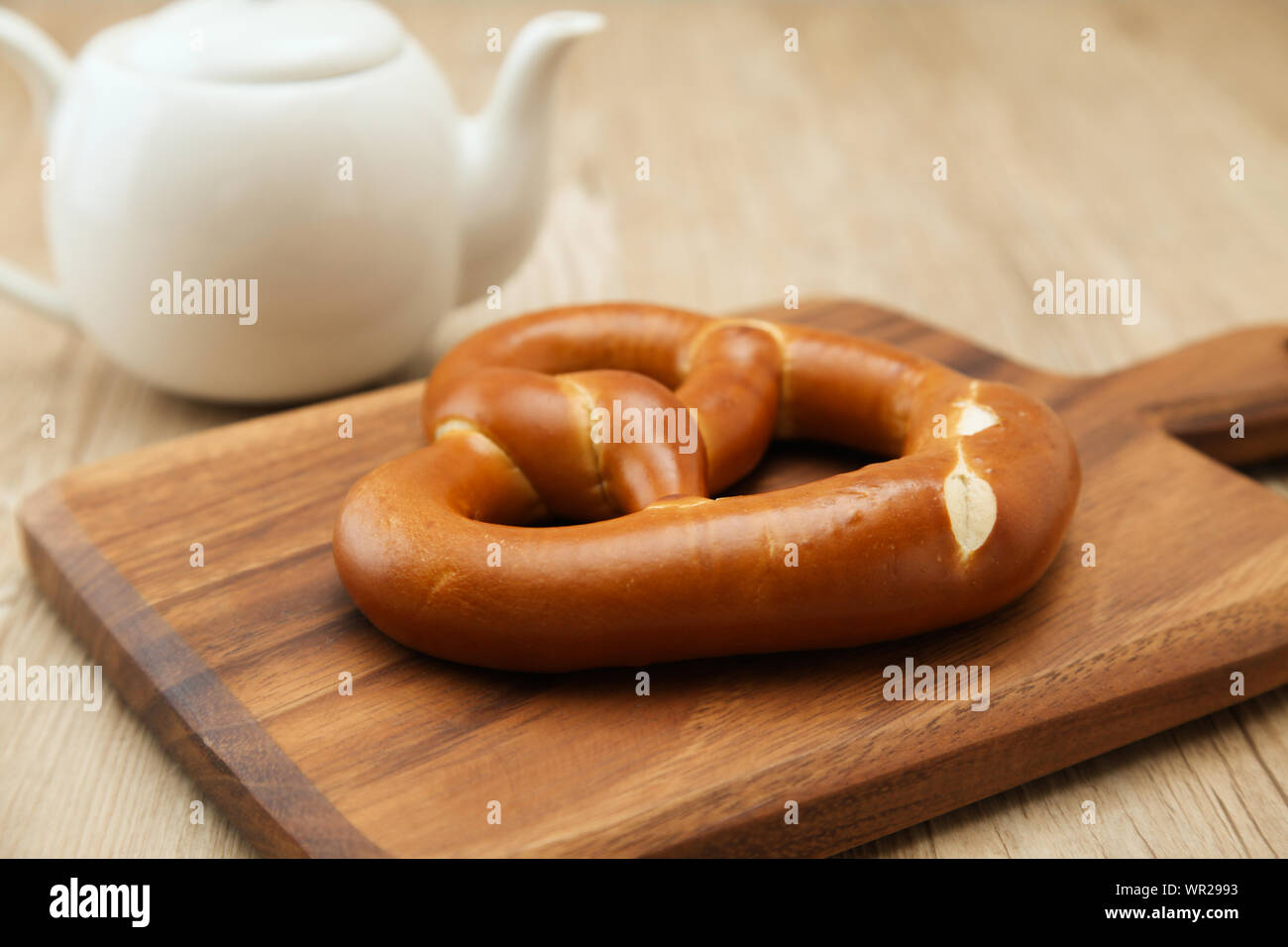 pretzel German bread on wood plate closeup isolated on table Stock Photo