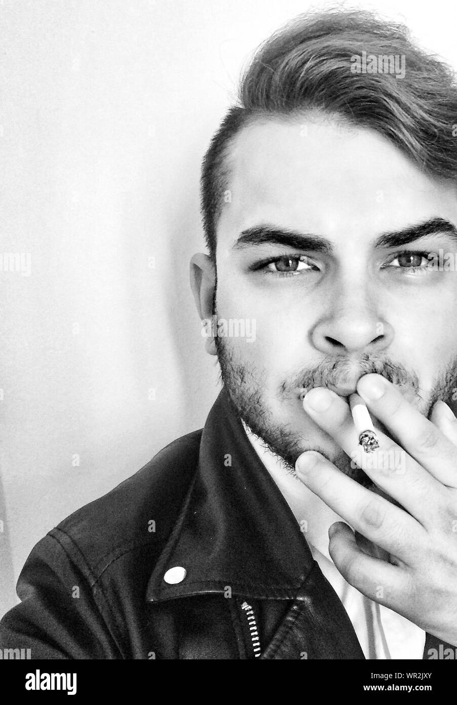 Portrait Of Young Man Against White Background Stock Photo Alamy