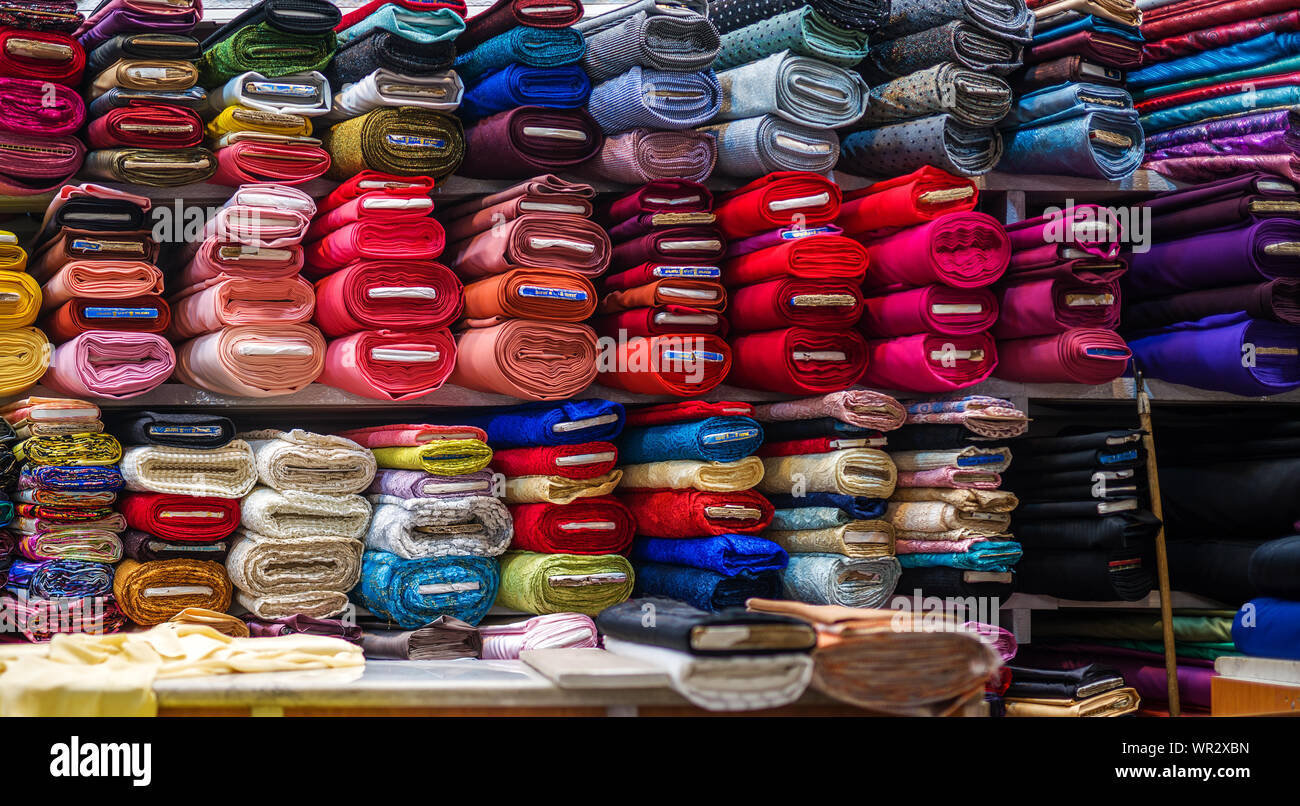 Rolls of fabric and textiles in a shop. a lot of colors and patterns Stock Photo