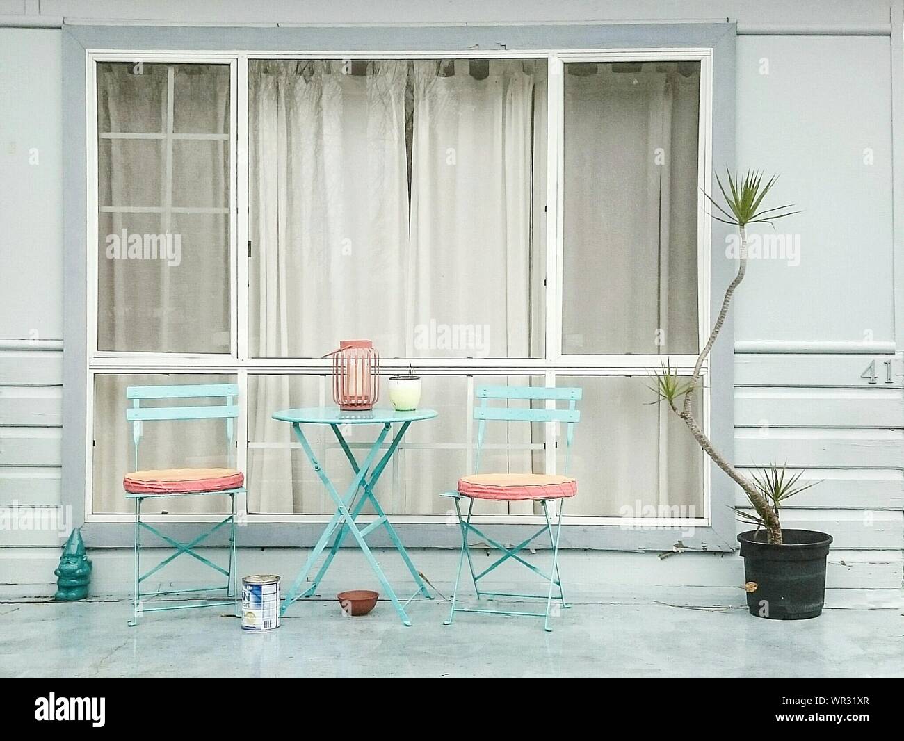 Table And Chairs Against Window Of House Stock Photo Alamy