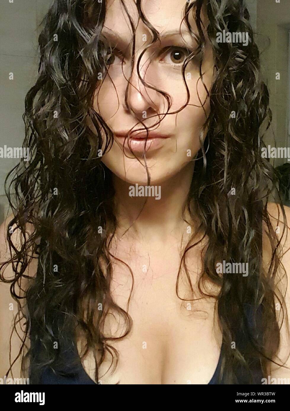 Portrait Of Woman With Messy Curly Hair At Home Stock Photo Alamy
