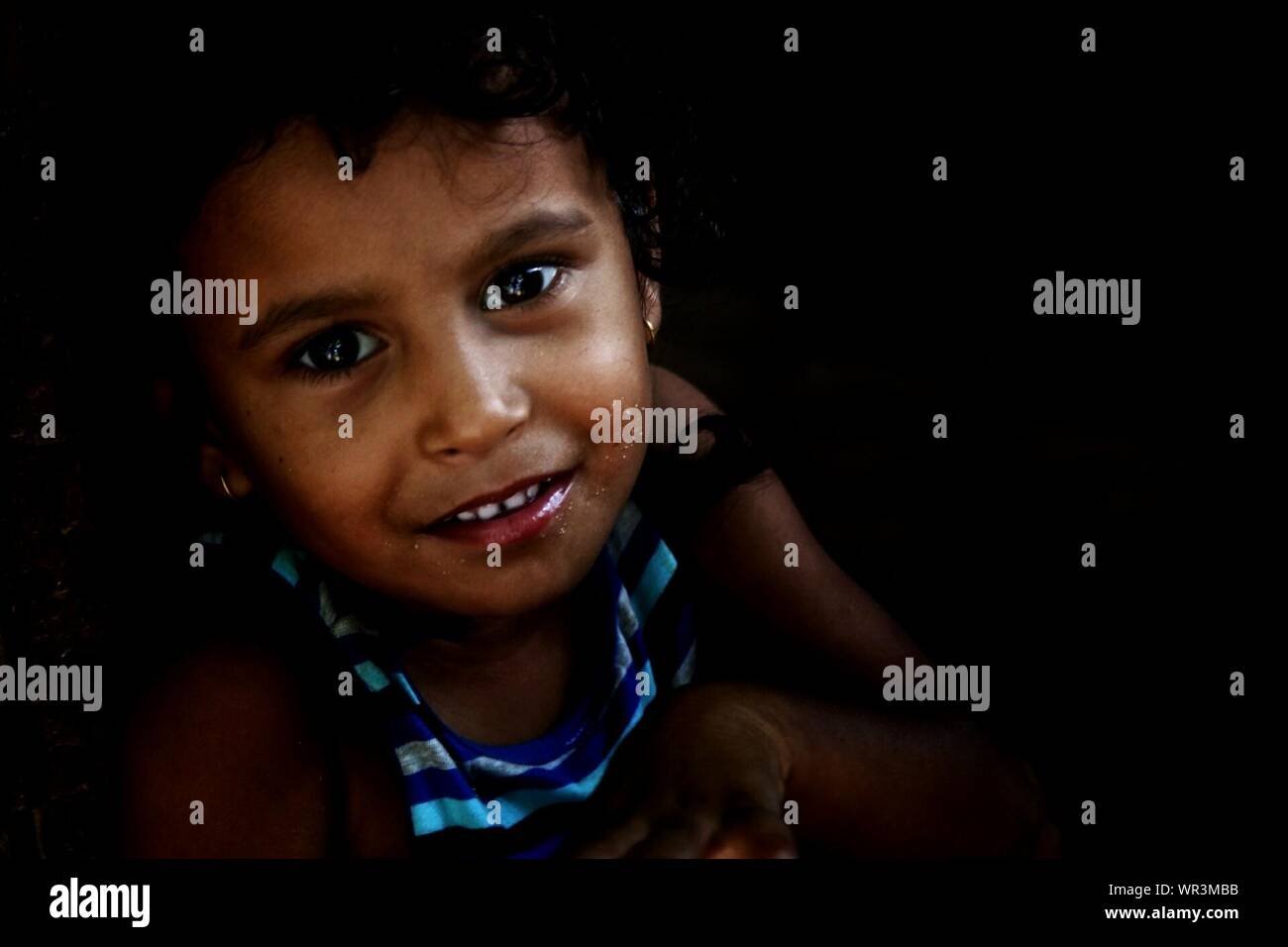 Close-up Portrait Of Cute Girl In Darkroom Stock Photo - Alamy