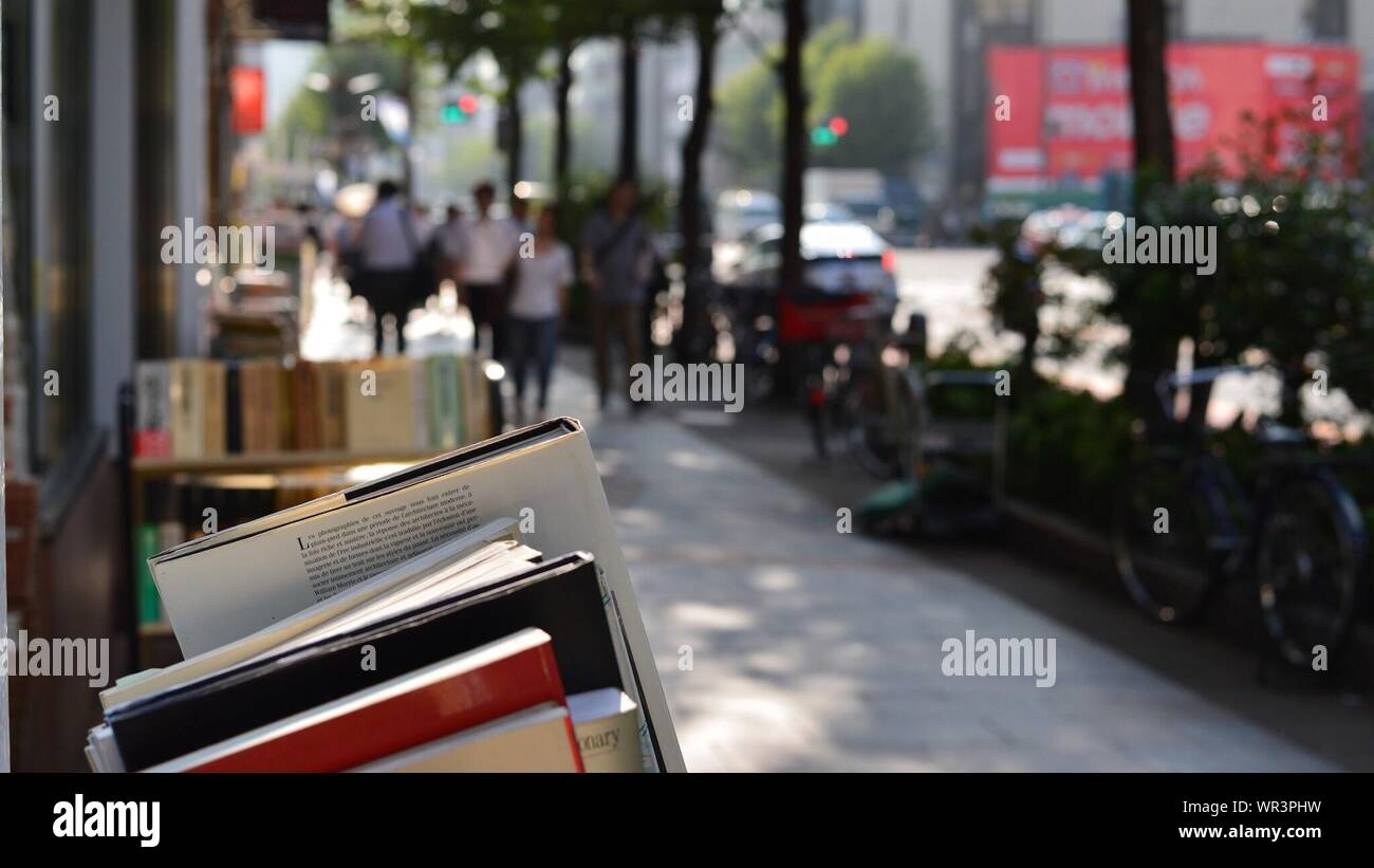 Close Up Image Of Books Exposed On Sidewalk Stock Photo