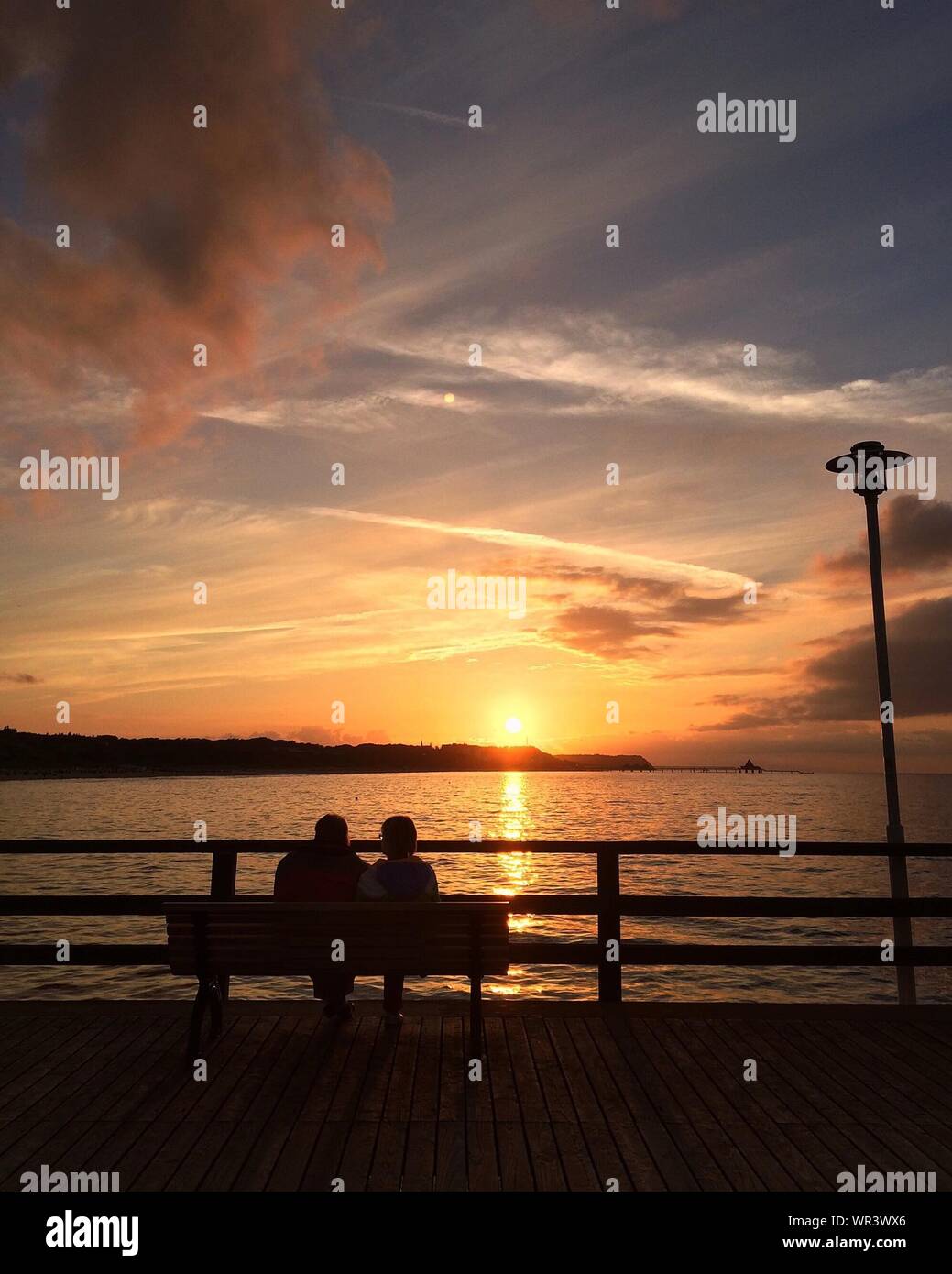 Silhouette Couple Sitting Bench Sunset Bench High Resolution Stock ...