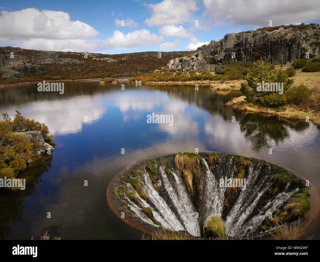 Sinkhole On Lake By Serra Da Estrela Mountain Range Stock Photo ...