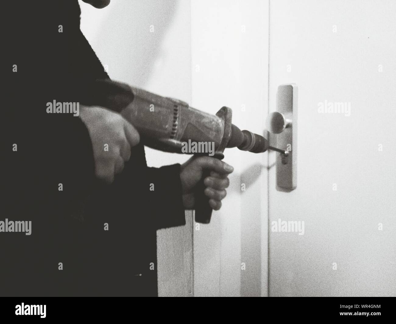 Thief Opening Door Lock With Power Drill Stock Photo Alamy