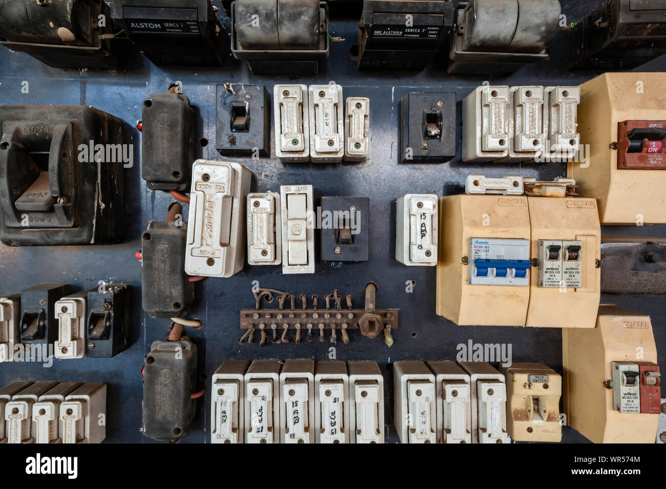 An old fuse box in Australia showing a variety of fuses and switches Stock Photo