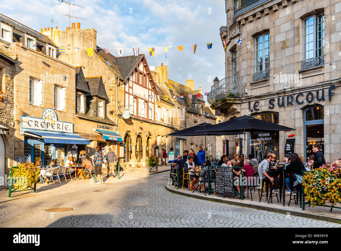 Roscoff, France - July 31, 2018: People enjoying dinners in restaurants and creperies in the old centre of the town. Stock Photo
