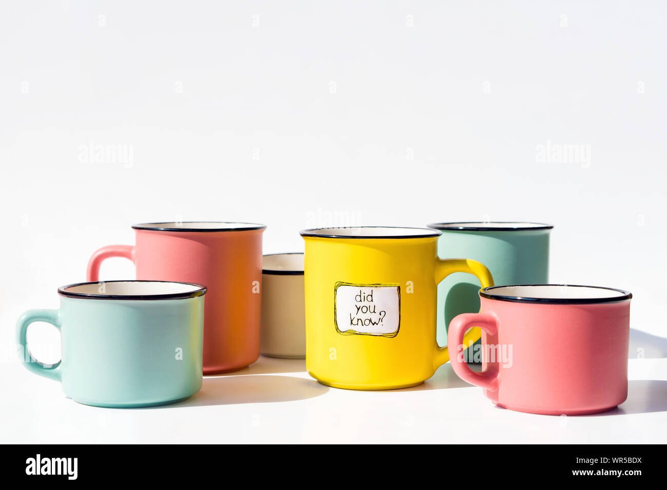 Several multi-colored coffee cups and one with the inscription Did you know Stock Photo