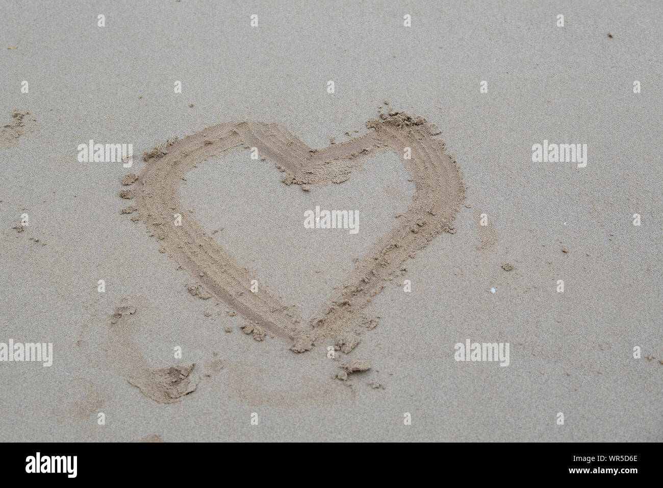 Heart drawn in sand on a beach, How romantic -  Northern Ireland, UK. Stock Photo