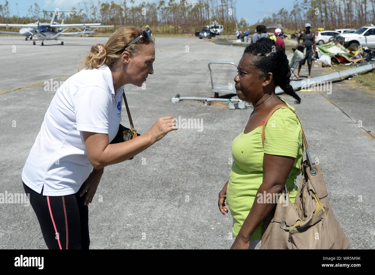 Treasure Cay, The Bahamas. 9th Sep 2019. Broward County business woman, Christina Henley comforts a Bahamian woman during her visit to Treasure Cay in the Bahamas on September 9, 2019. The stop on Treasure Cay, The Bahamas was conducted to provide consumable and medical products to the local population. The visit was coordinated by 'Shipwreck Park', a 501 (c) (3) corporation which is responsible for the acceptance and distribution of relief goods, consumables and medical supplies for the island chain. Credit: UPI/Alamy Live News Stock Photo