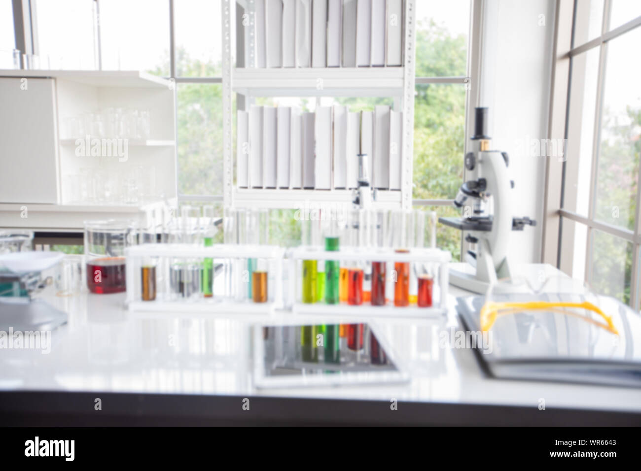 Blurry of microscope and a tablet and Test Tubes, Micropipette and