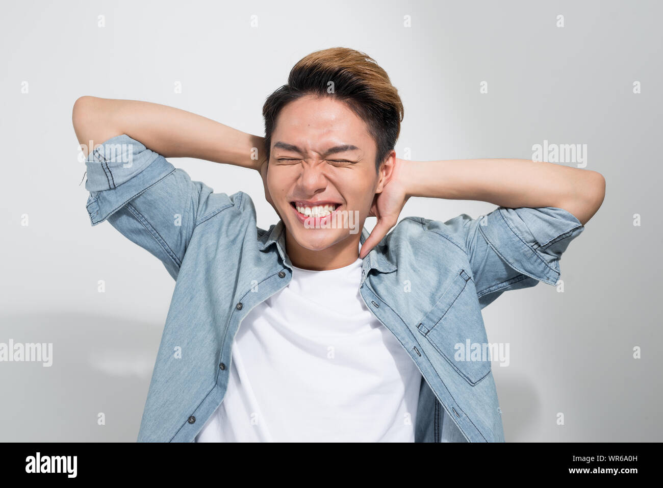 A portrait of happy excited young Asian man isolated on white ...