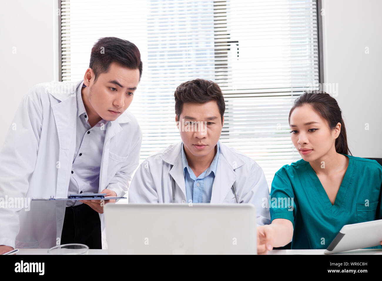 Doctor team working at computer desk in hospital Stock Photo - Alamy