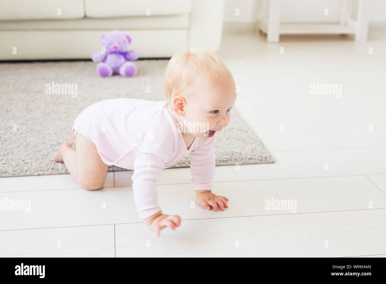 beautiful smiling baby crawling for the first time Stock Photo - Alamy