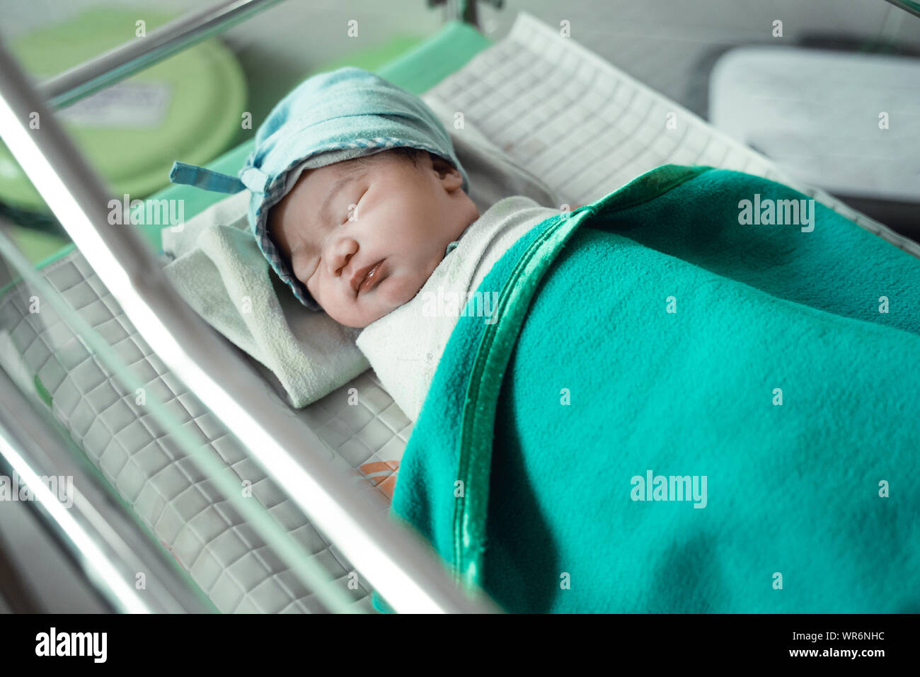 Newborn baby laying in crib Stock Photo Alamy