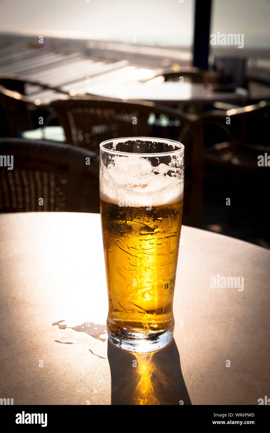 a glas of Grolsch beer, not full, Walcheren, Zeeland, Netherlands.  nicht mehr volles Bierglas, Grolsch, Walcheren, Zeeland, Niederlande. Stock Photo