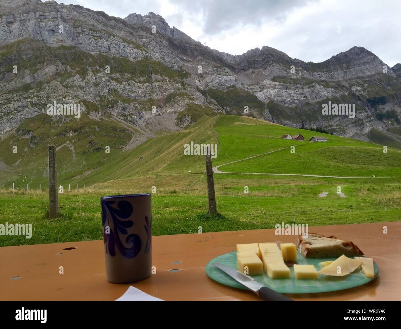 View Of Alpstein With Breakfast In Foreground Stock Photo