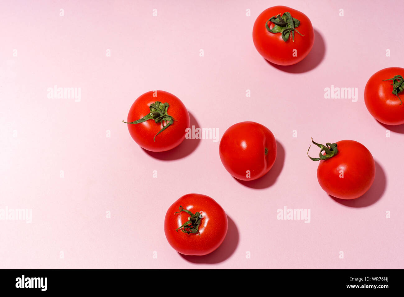 Pattern with cherry tomatoes on pink background Stock Photo