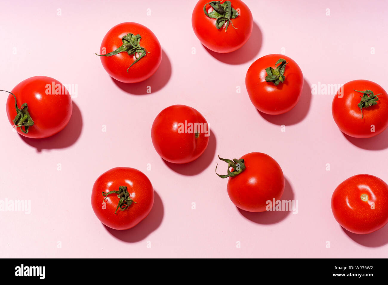 Pattern with cherry tomatoes on pink background Stock Photo