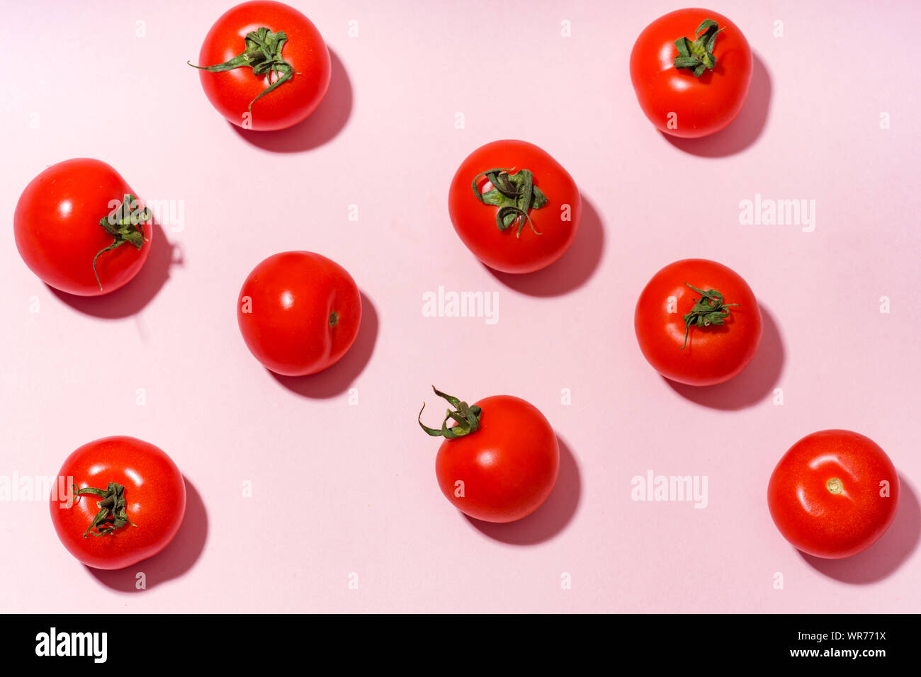 Pattern with cherry tomatoes on pink background Stock Photo