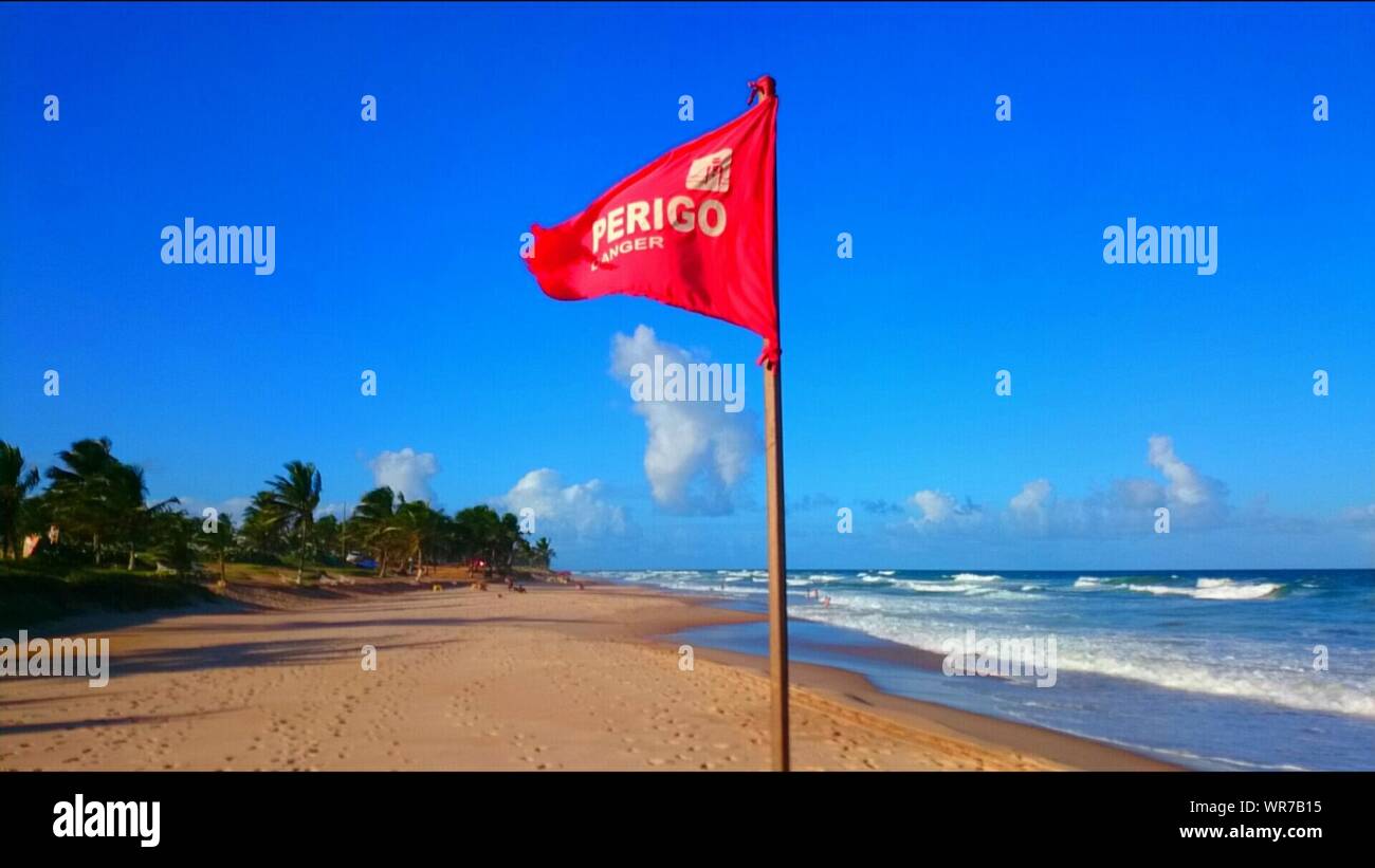 Red Flag At Flamengo Beach Against Blue Sky Stock Photo