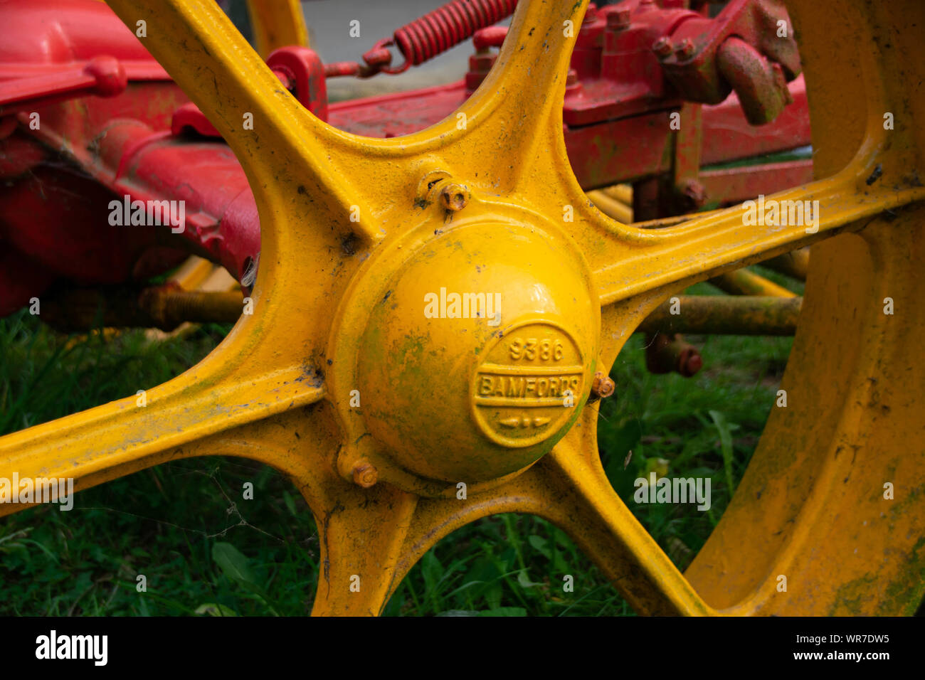 A bright yellow old fashioned tractor wheel Stock Photo