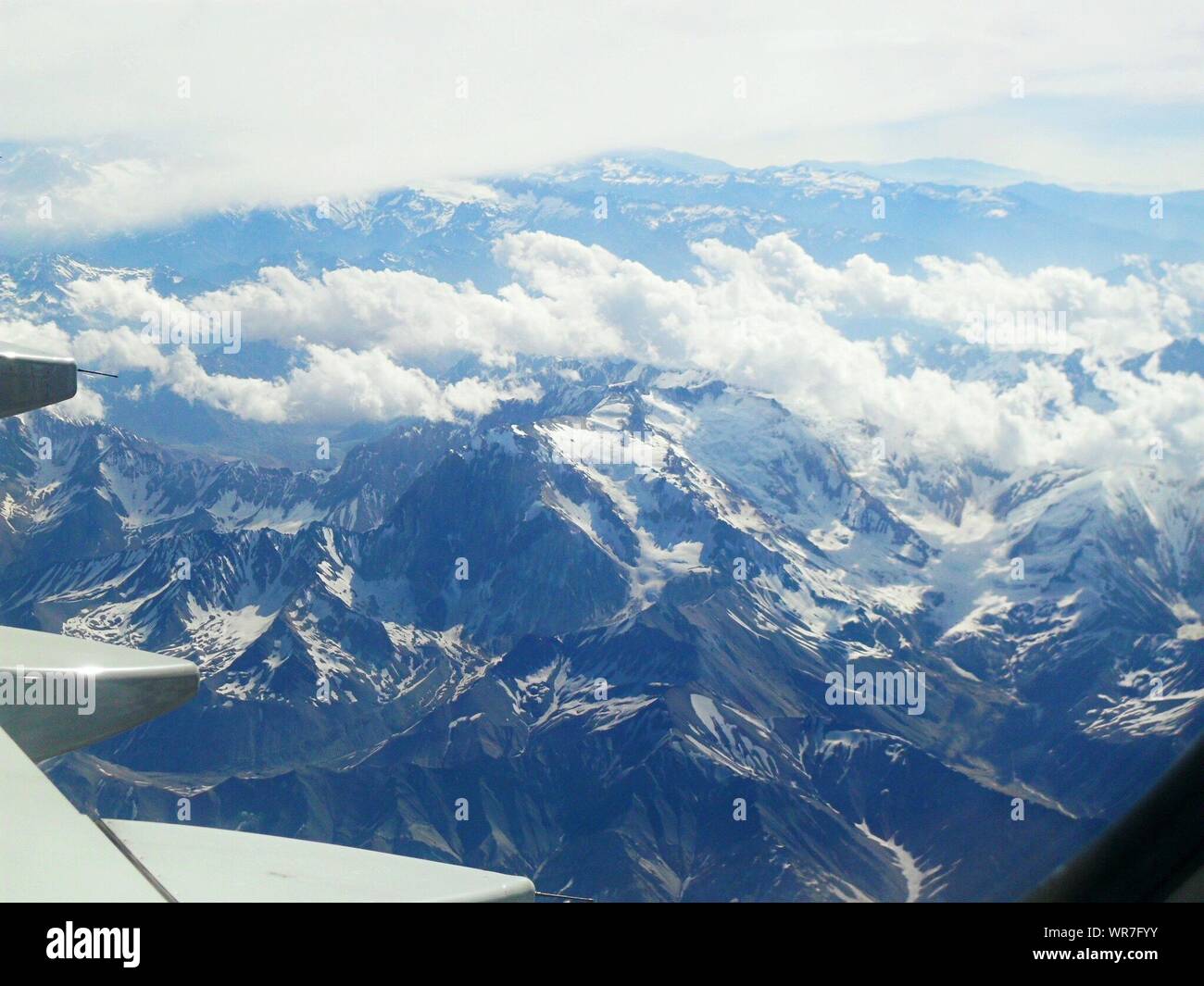 Cropped Image Of Airplane Over Andes Mountain Ranges Stock Photo