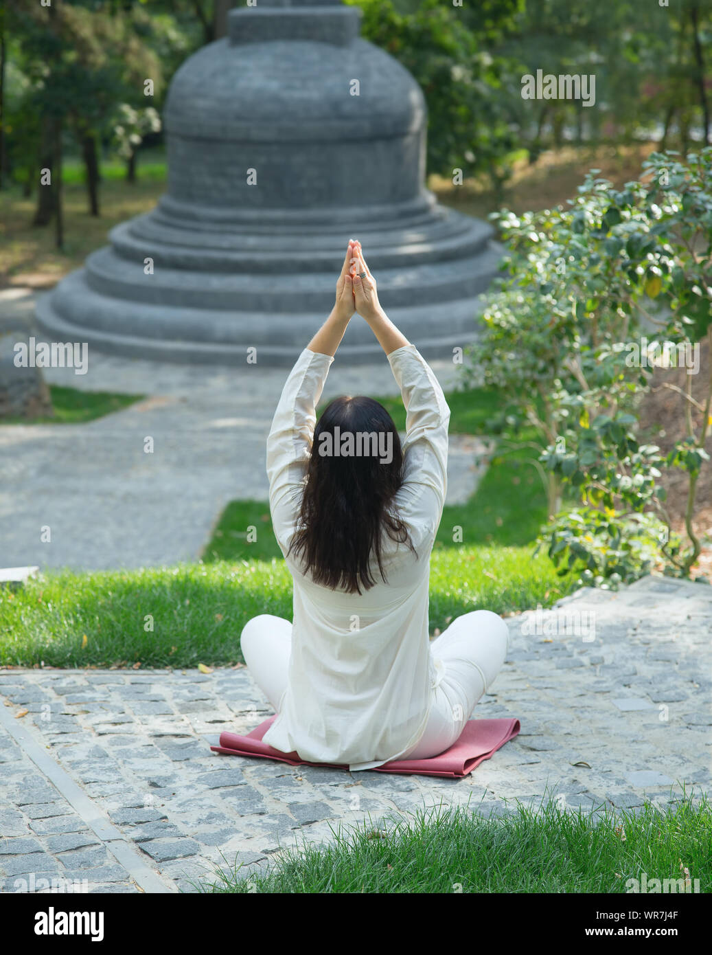 Asian woman practicing yoga, meditation in lotus position on nature ...