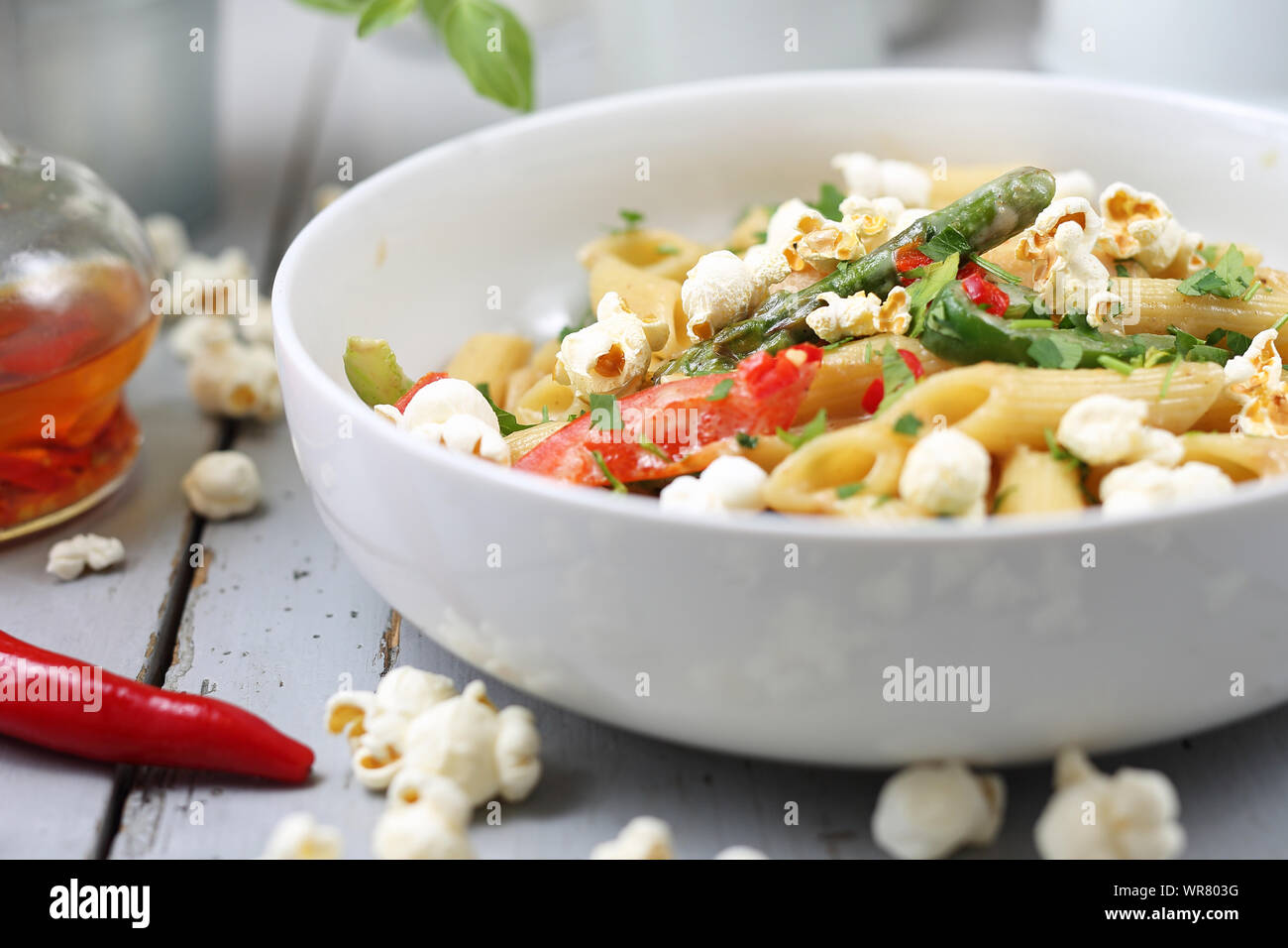 Penne pasta with asparagus, smoked tofu, chilli peppers and mini corn onions in nut sauce Stock
