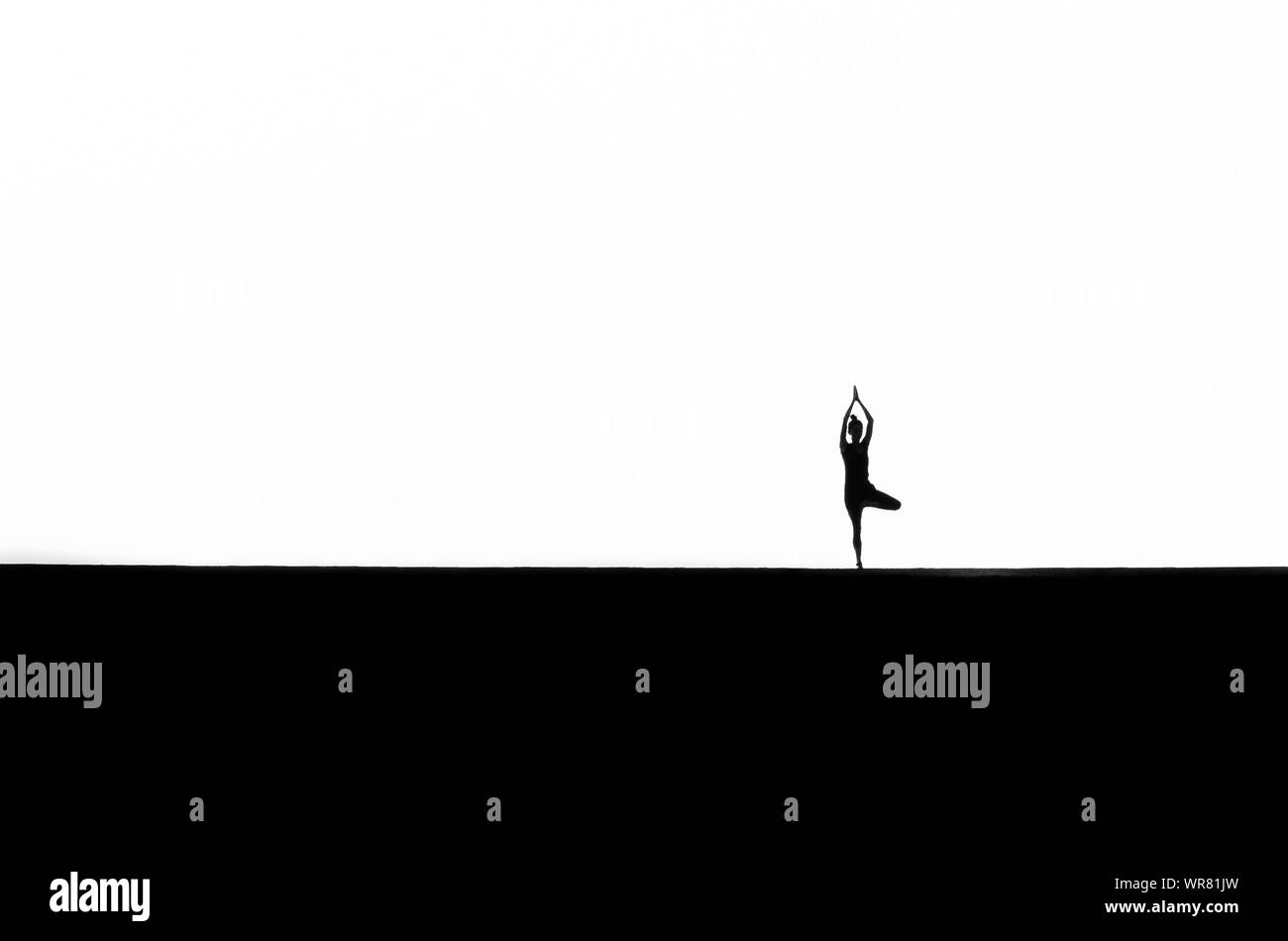 Silhouette of yoga tree pose Black and White Stock Photos & Images - Alamy