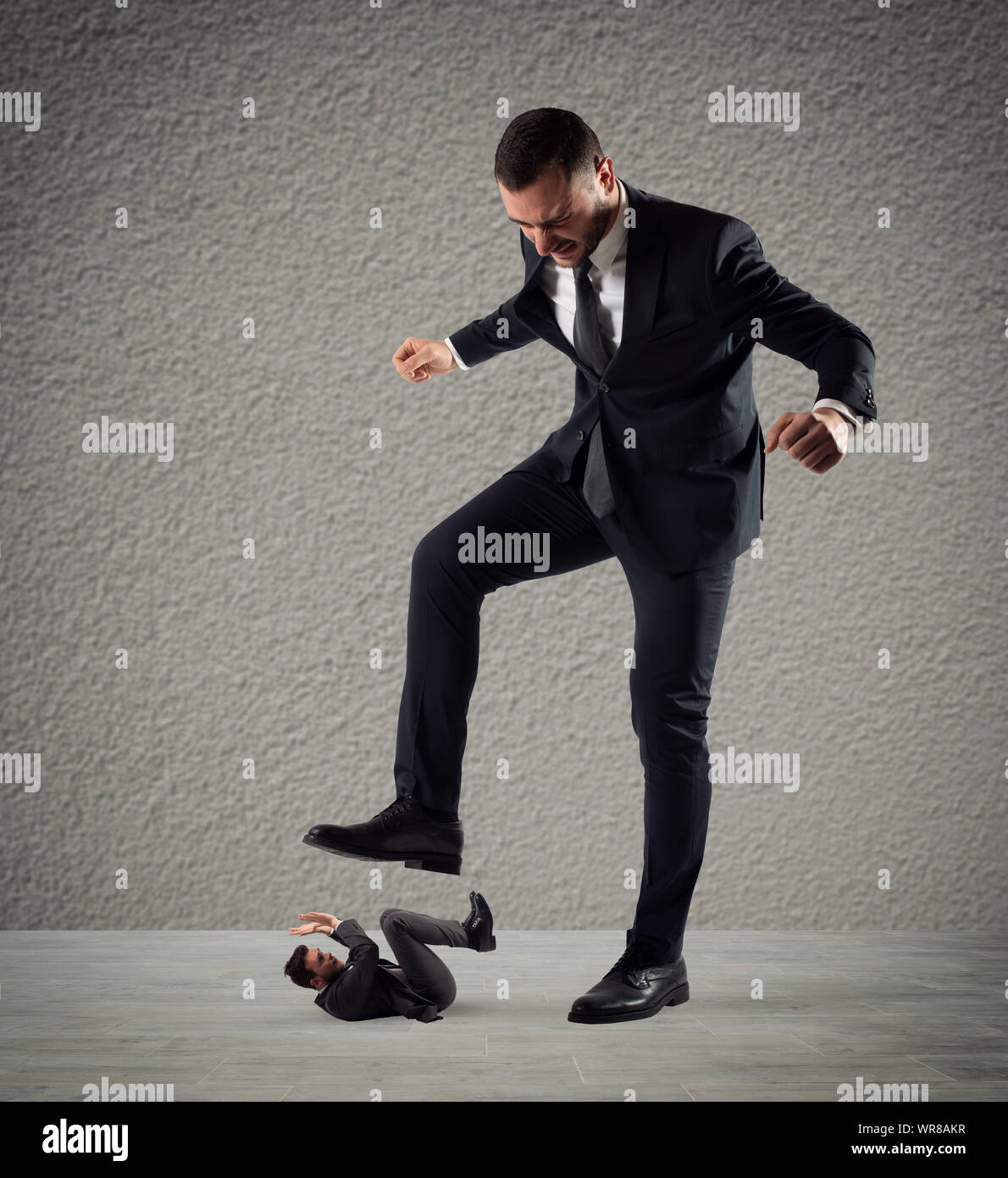 Furious businessman who want to trample his employee Stock Photo