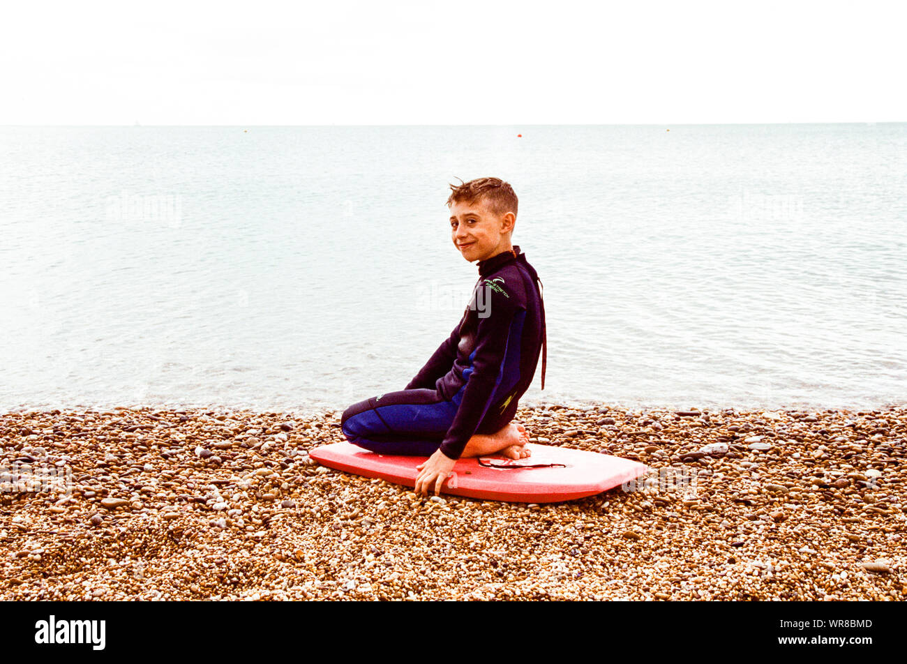10 year old boy in a wet-suit at Blackpool Sands, Blackpool, Dartmouth,Devon, England, United Kingdom. Stock Photo