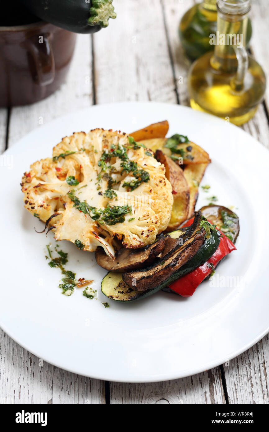 Cauliflower with mushrooms baked potatoes. Vegetarian cooking Stock Photo