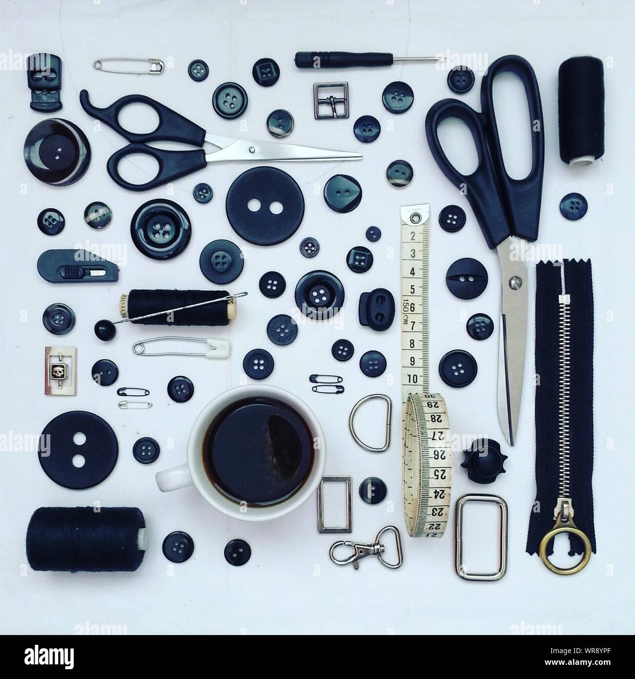 Directly Above Shot Of Sewing Item Arranged On Gray Background Stock Photo