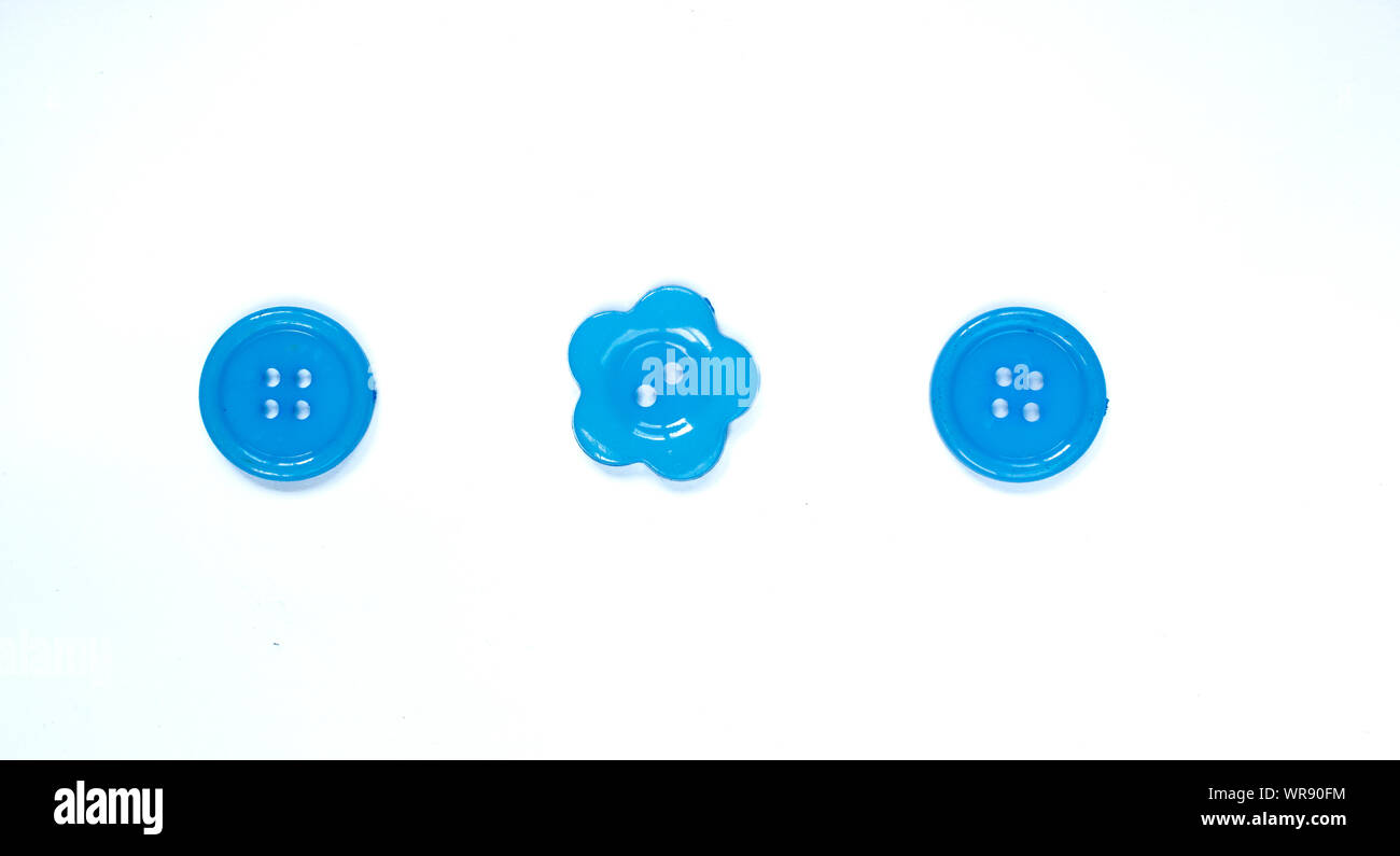 Three Various blue sewing buttons isolated on background. Stock Photo