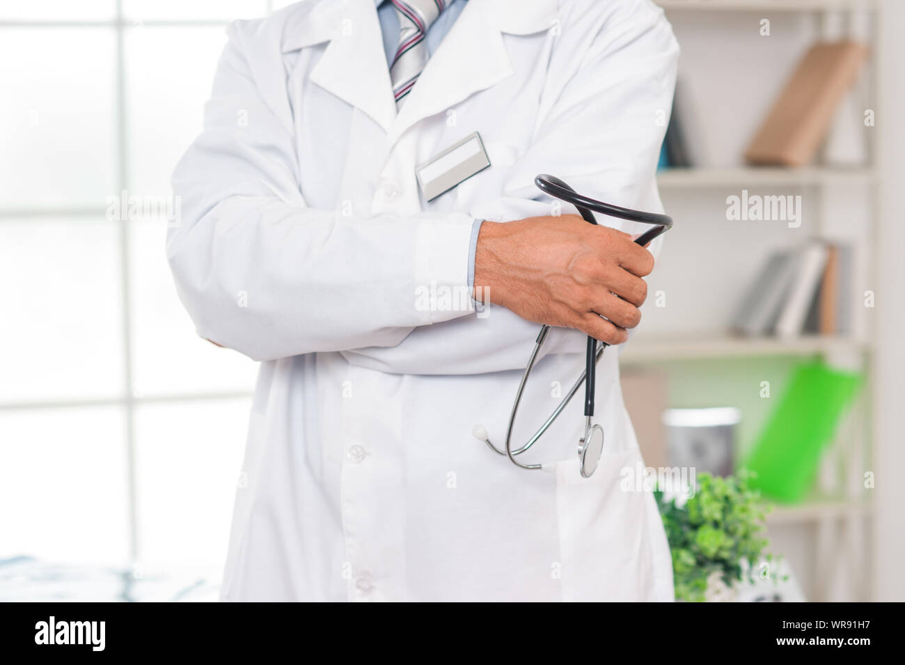 Senior doctor at his office in hospital carry stethoscope closeup