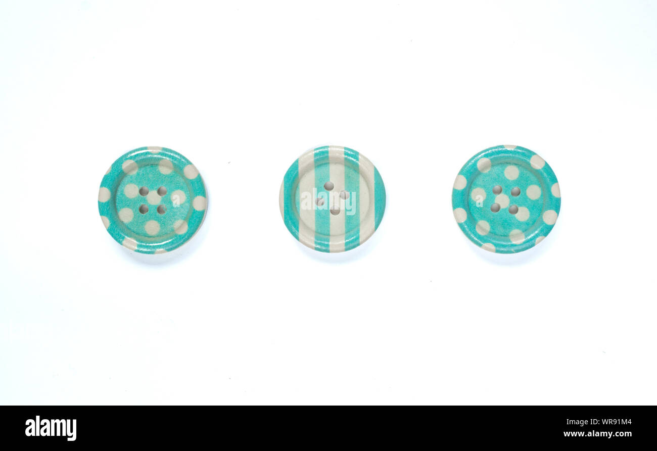Three Various blue sewing buttons isolated on background. Stock Photo