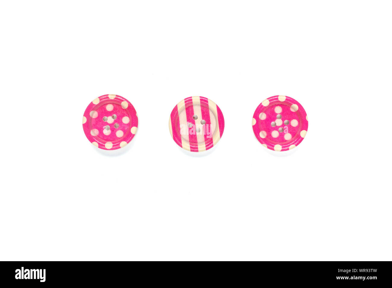 Three Various pink sewing buttons isolated on background. Stock Photo
