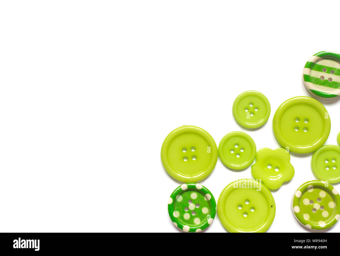 Various green sewing buttons isolated on white background. Stock Photo