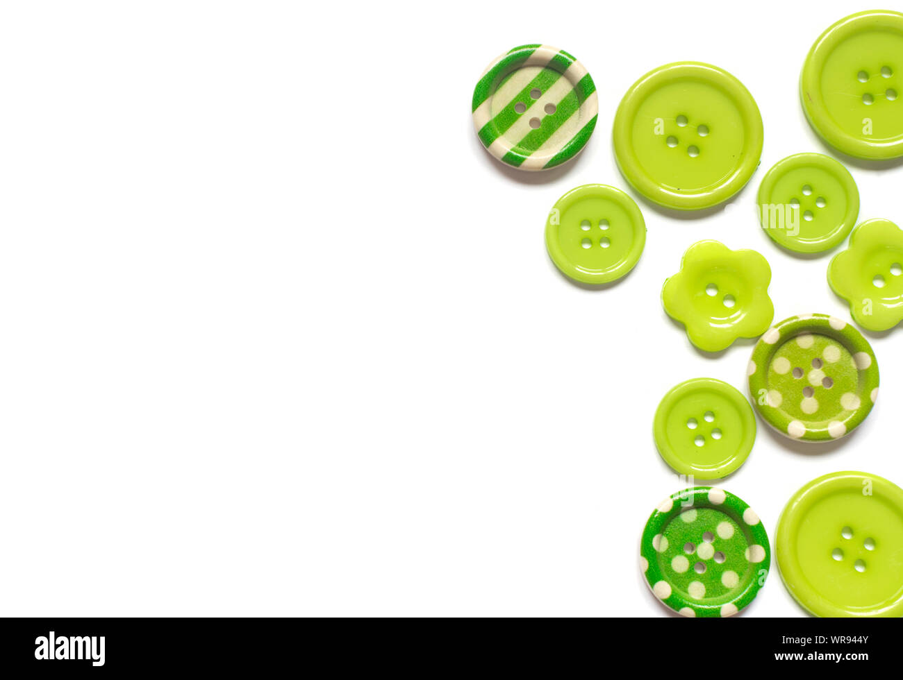 Various green sewing buttons isolated on white background. Stock Photo