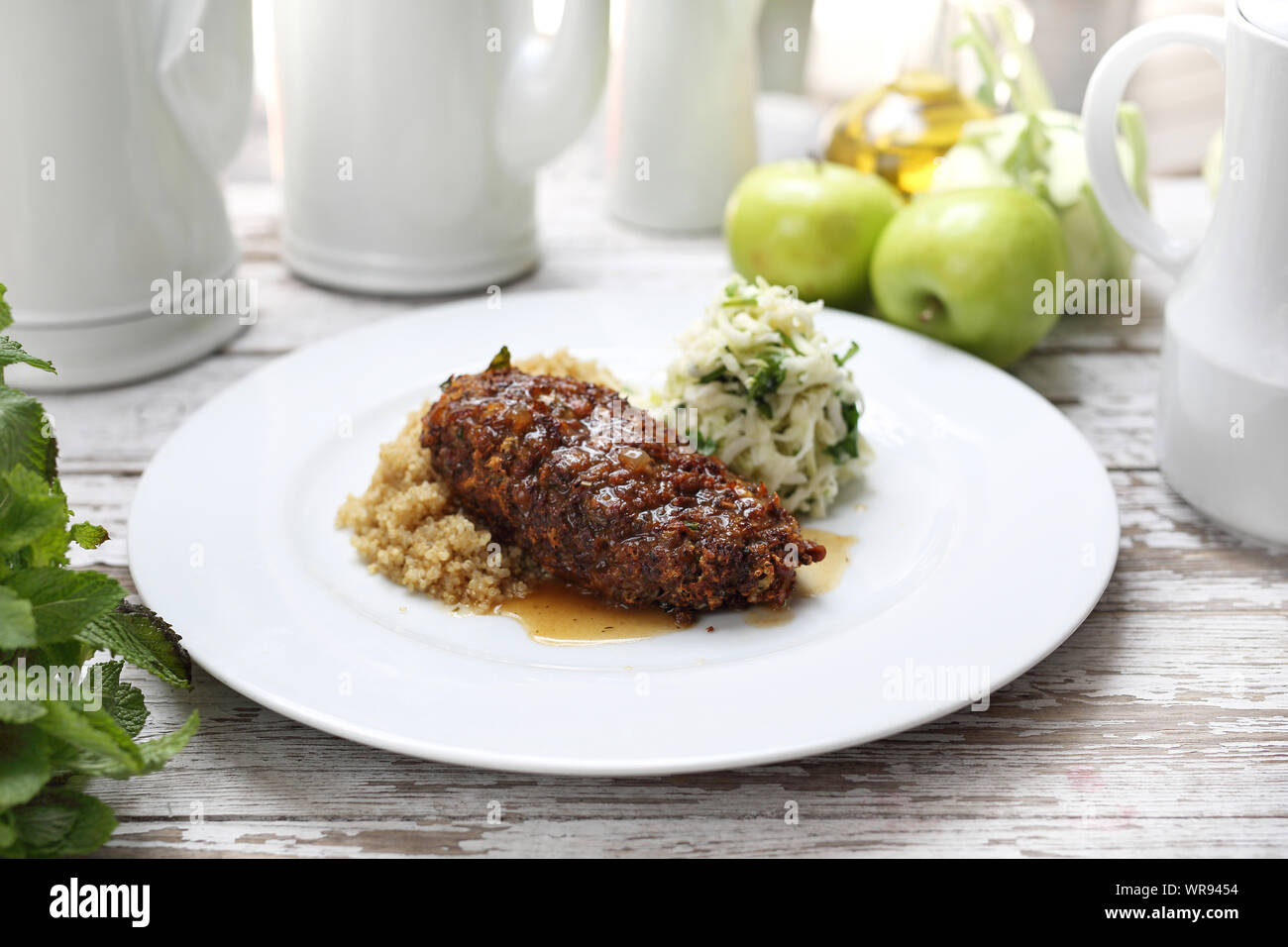 Vegetarian cuisine. An appetizing vegetable chop dish served with groats and salad. Stock Photo