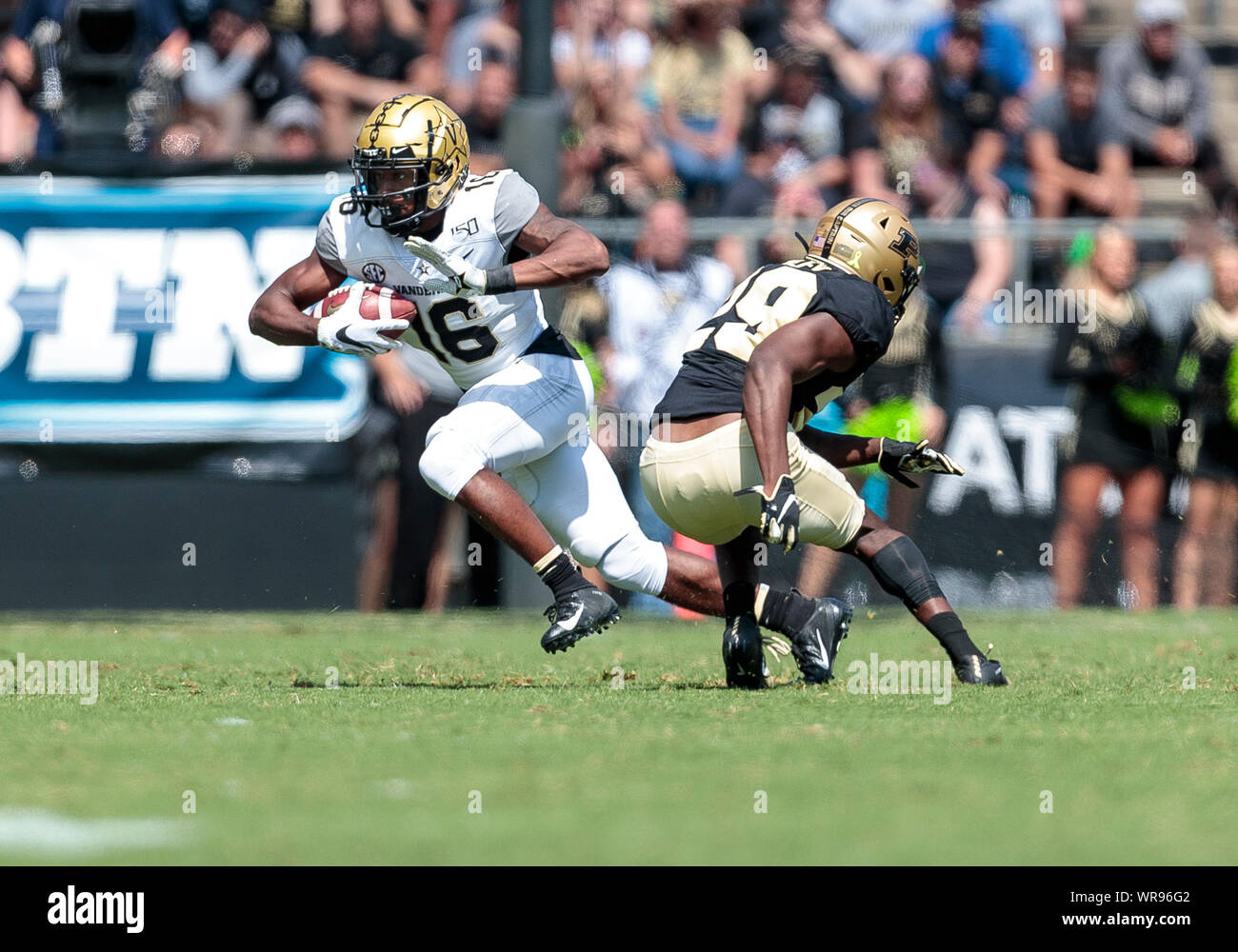 West Lafayette, Indiana, USA. 07th Sep, 2019. Vanderbilt wide receiver Kalija Lipscomb (16) runs with the ball as Purdue defensive back Simeon Smiley (29) pursues during NCAA football game action between the Vanderbilt Commodores and the Purdue Boilermakers at Ross-Ade Stadium in West Lafayette, Indiana. Purdue defeated Vanderbilt 42-24. John Mersits/CSM/Alamy Live News Stock Photo