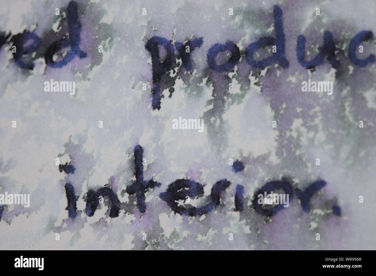 Handwritten text on paper sprinkled with water to create a mosaic