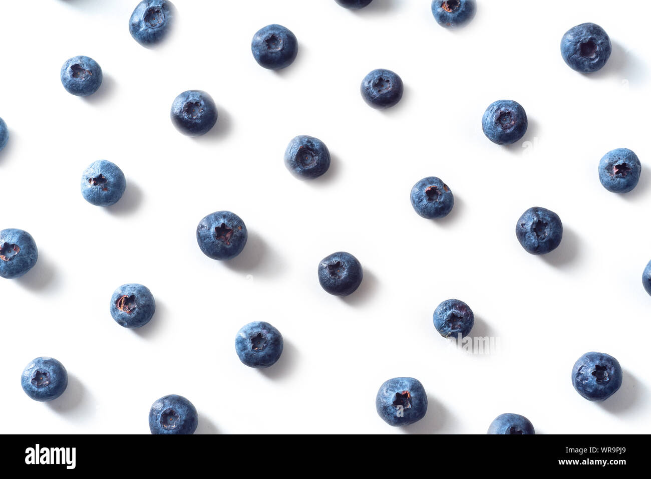 Flatlay pattern with fresh ripe blueberries isolated on white background Stock Photo