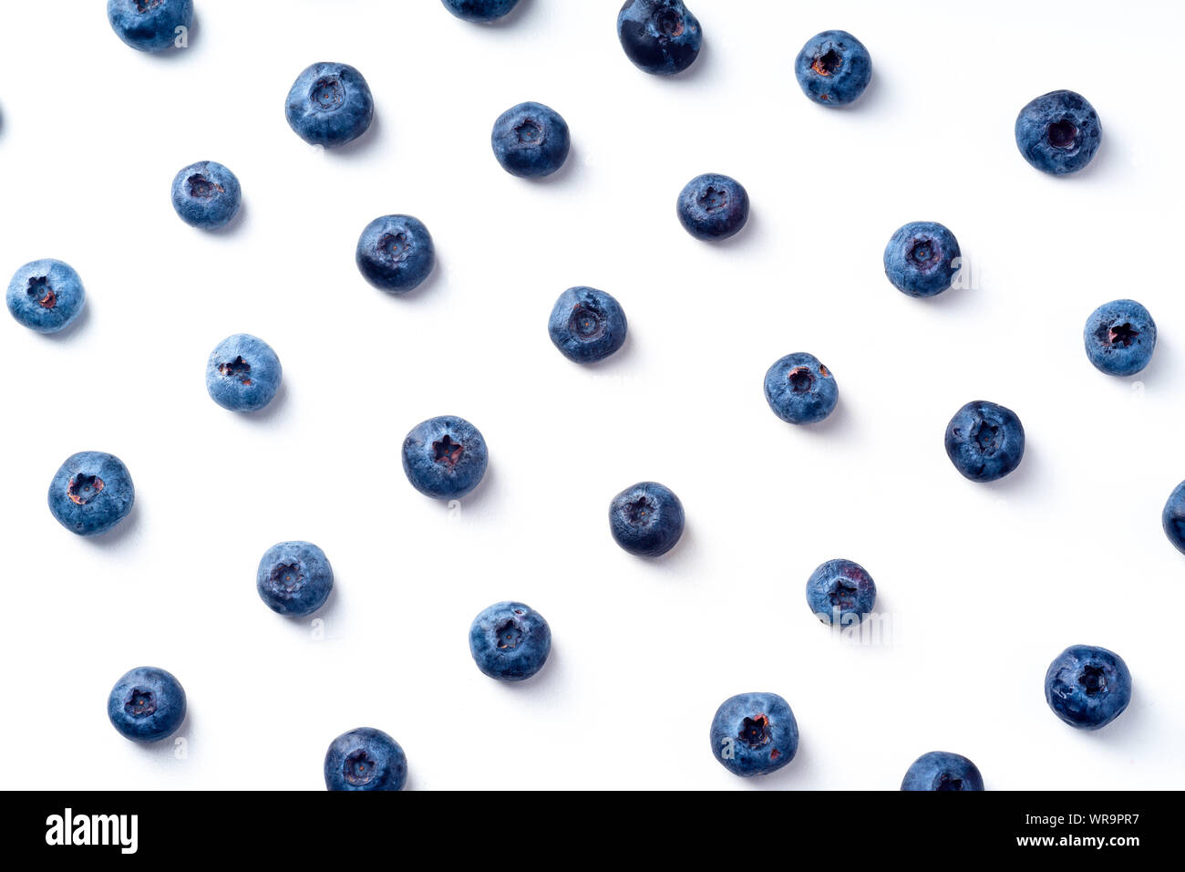 Flatlay pattern with fresh ripe blueberries isolated on white background Stock Photo