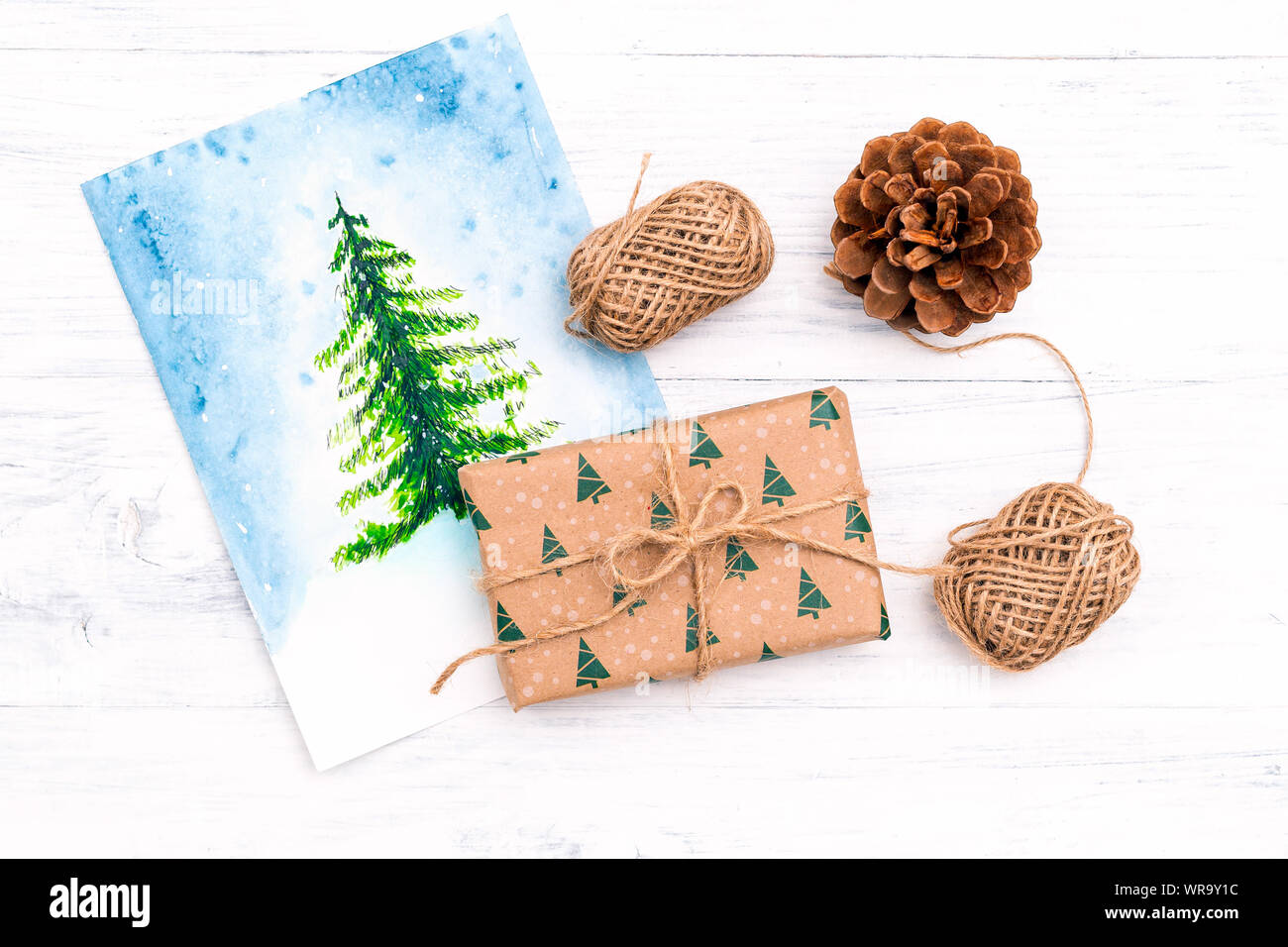 Christmas gift box and watercolor tree on wooden background. Christmas ...