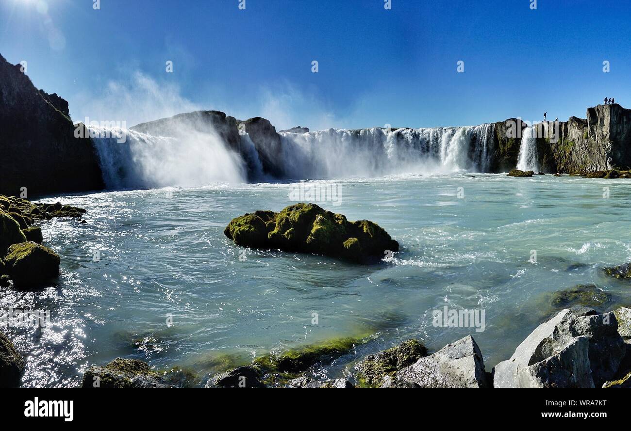View Of Waterfall Against Blue Sky Stock Photo