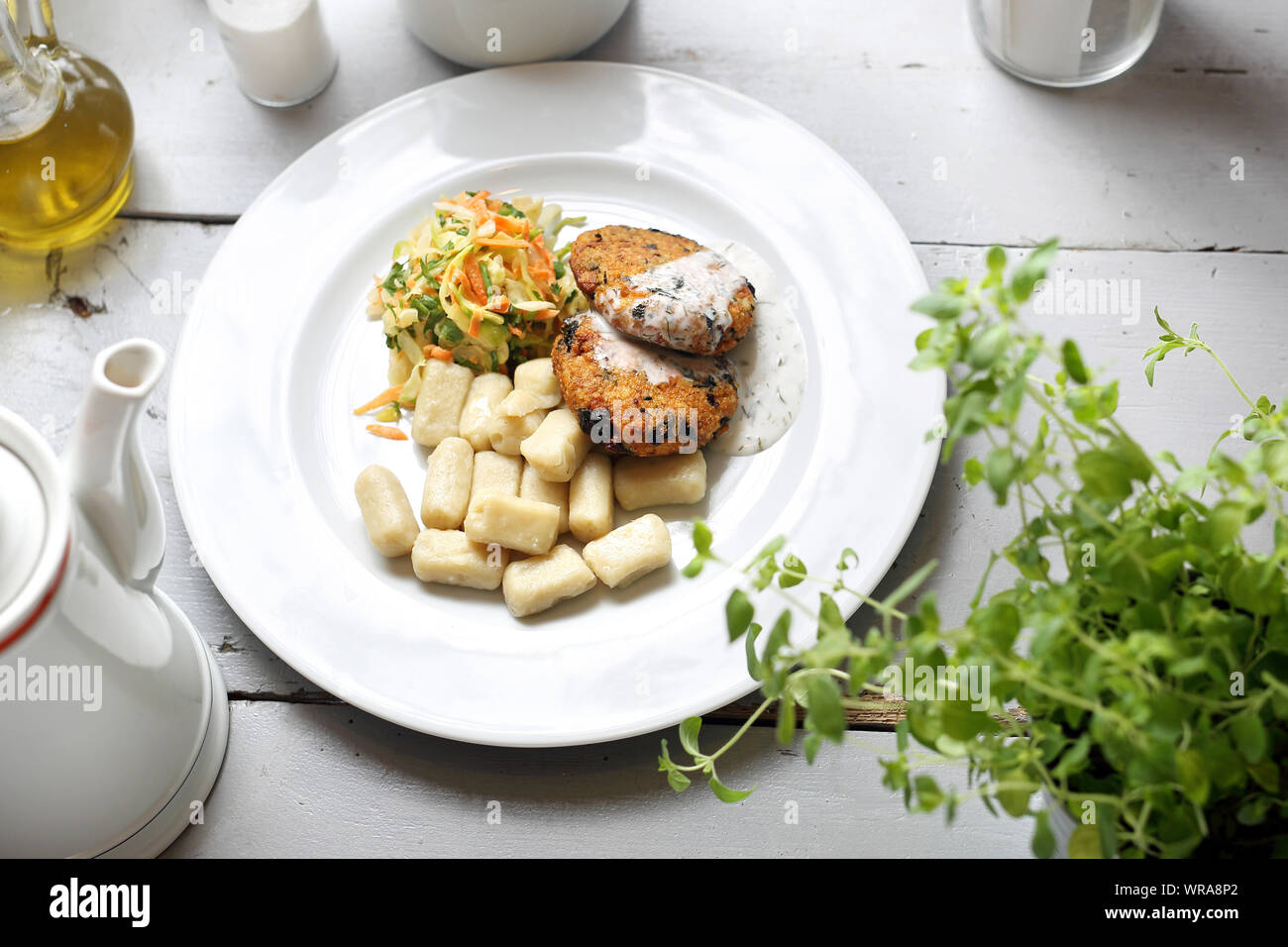 Vegetarian lunch, healthy vegetable cutlet with dumplings and white cabbage salad. Stock Photo